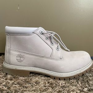 Light lilac colored timberland boots. Ankle height. Women’s size 7.5.